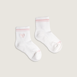 Load image into Gallery viewer, Two white socks with pink accents on a light beige background