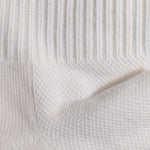 Load image into Gallery viewer, Close-up of textured white fabric with a subtle mesh pattern