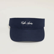 Navy visor with 'Cafe Apres' embroidery on a light gray background