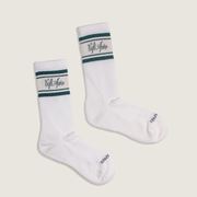 Pair of white socks with green accents and 'Cafe Apres' branding on a beige background