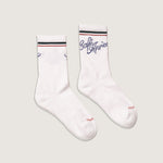 Load image into Gallery viewer, White socks with green and red accents on a light gray background with Café Après logo in blue
