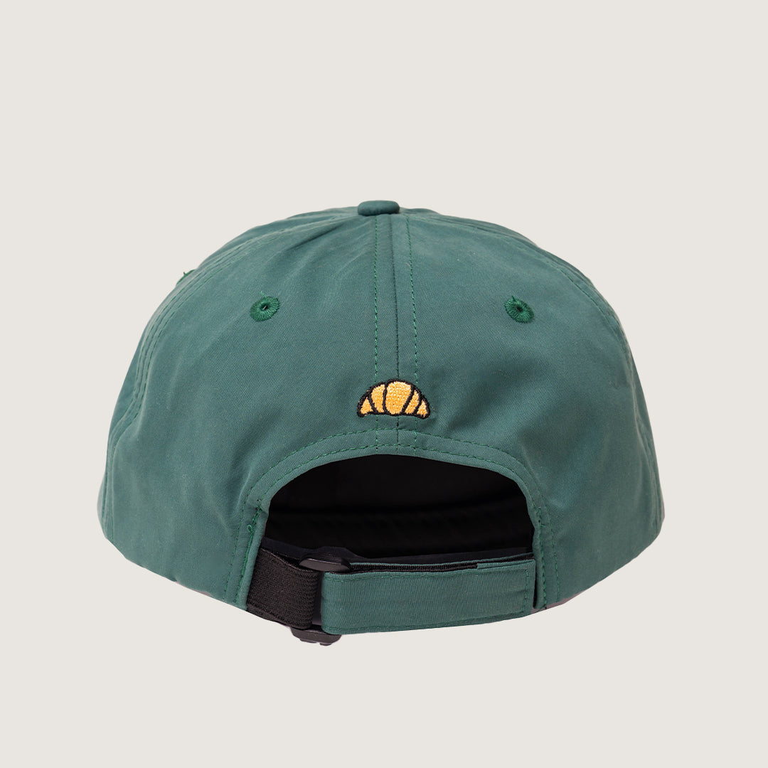 Green cap with a logo on the back against a light gray background