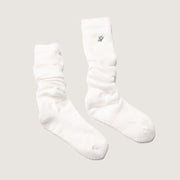 White socks with a small logo on a light gray background
