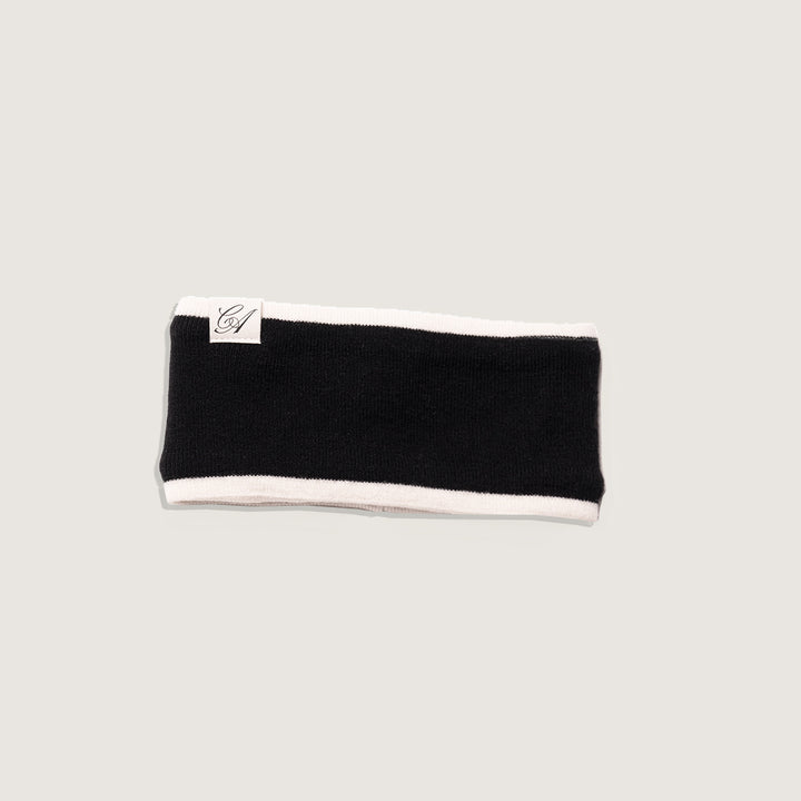 Black headband with white trim on a light gray background