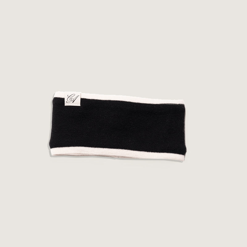 Black headband with white trim on a light gray background