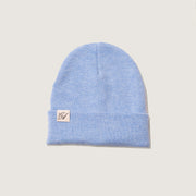 Light blue beanie with a brand logo on a beige background