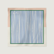 Striped fabric square with a brand name on a light pink border