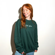 Person wearing a green sweatshirt with 'Café Après' text on a white background