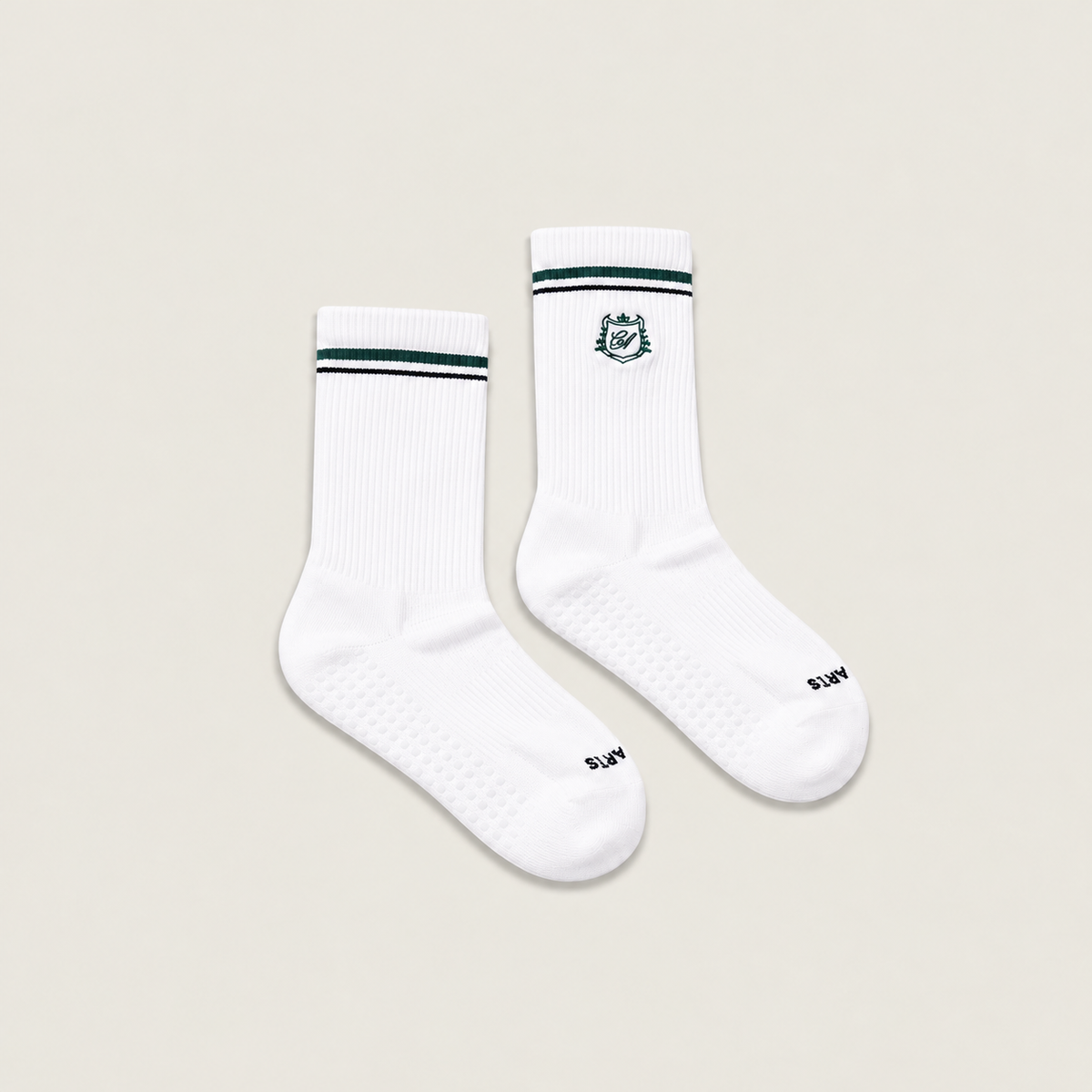 The Crest Crew Grip Sock — a crew-height grip sock with the Café Après crest and dual stripe detailing