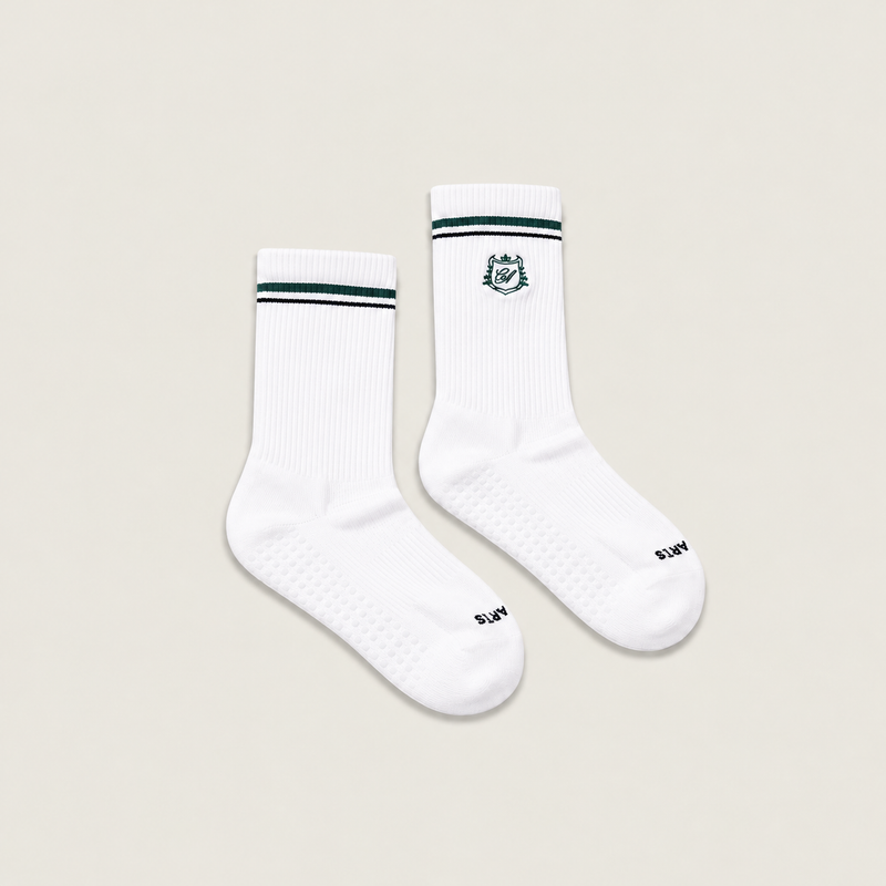 The Crest Crew Grip Sock — a crew-height grip sock with the Café Après crest and dual stripe detailing